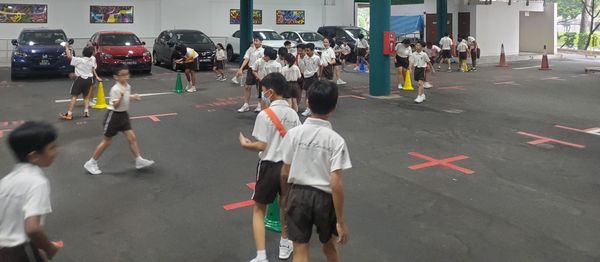 Students playing Chef Safari in a car park