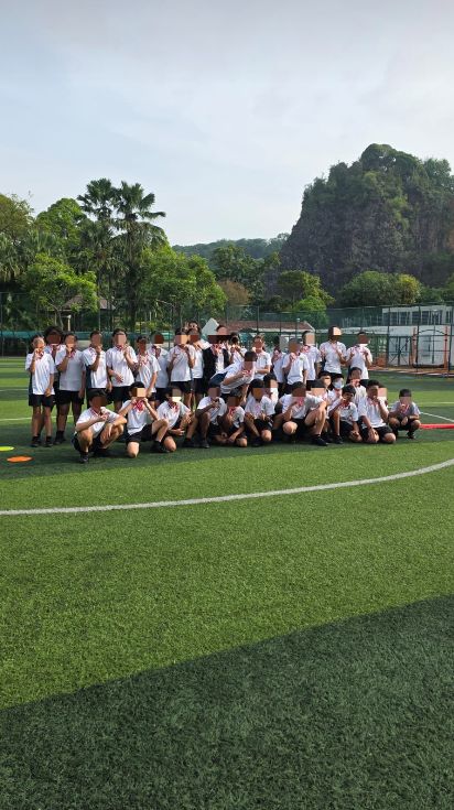 A group of Lianhua Primary School students with their medals on the football pitch after the Inter-Class Games.