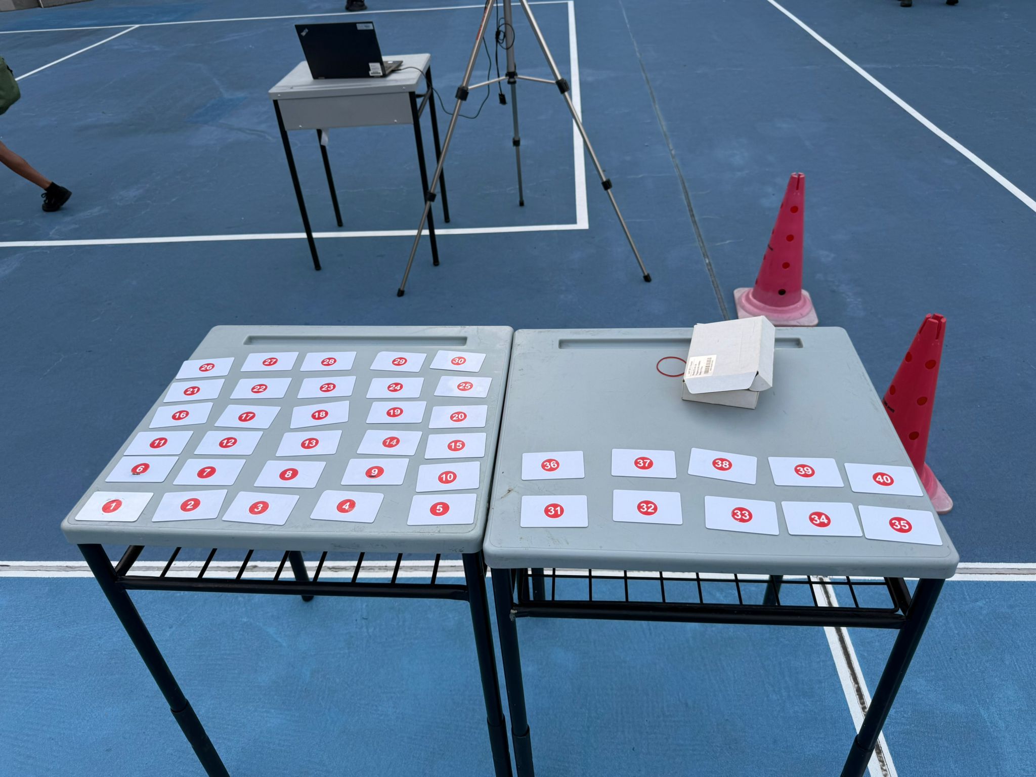 RFID cards numbered by student class index laid out on tables before a run